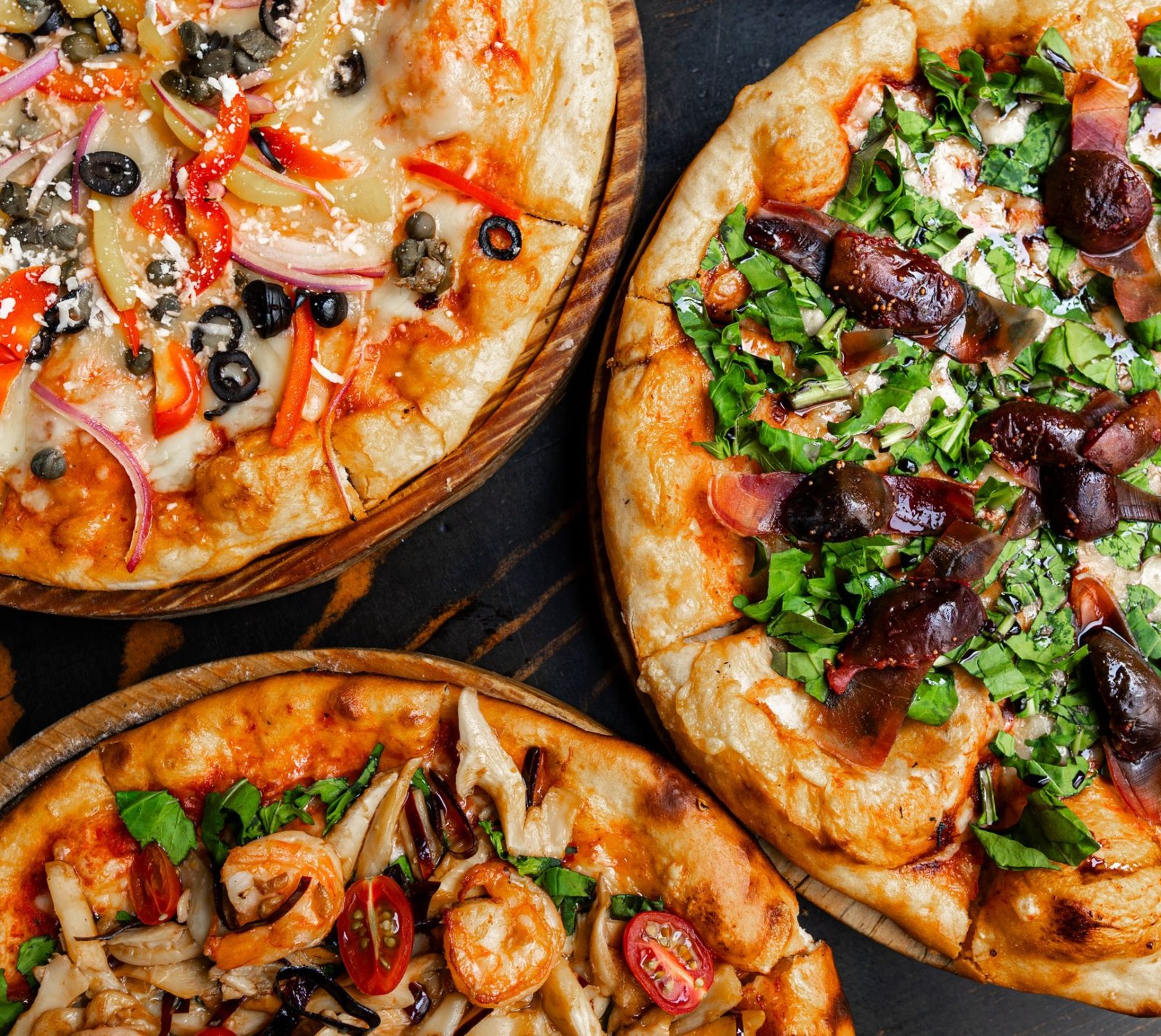 Four pizzas on boards, overhead